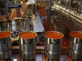 Cans of tomato soup make their way through the processing line at Highbury Canco in this 2014 file photo.