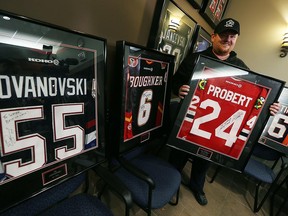 Windsor Minor Hockey Association president Dean Lapierre stands with the five autographed hockey jerseys that were previously stolen from the association's boardroom. Police recovered and returned the jerseys to WMHA on Jan. 15, 2016.