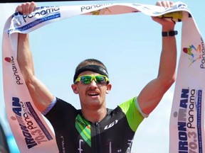 Lionel Sanders of Harrow celebrates after capturing gold at the Ironman 70.3 Panama on Jan. 31, 2016.