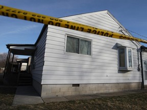 Police tape surrounds a house at 1596 Aubin Rd. where 52-year-old John Jubenville was murdered on March 23, 2013.