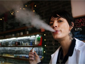 NEW YORK, NY - DECEMBER 19:  Catharine Candelario, an employee at the newly opened Henley Vaporium, vapes, or smokes an electronic cigarette, on December 19, 2013 in New York City. The New York City Council on Thursday will vote on a bill that would add electronic cigarettes to the city's strict smoking ban. If the Mayor Bloomberg backed ban is approved, the city would give businesses and restaurants a year to put up signs indicating there is no smoking or vaping allowed. The Henley Vaporium features a smoking bar and a coffee bar where tea and snacks are served in a relaxed environment.