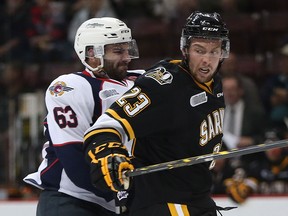 Windsor Spitfires Bradley Latour and Sarnia Sting's  Zachary Core are pictured in this 2015 file photo.