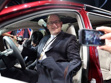 Windsor Mayor Drew Dilkens sits in the new 2017 Chrysler Pacifica at the 2016 North American Auto Show on Jan. 11, 2016 in Detroit, Mich.