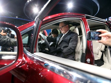 Windsor Mayor Drew Dilkens sits in the new 2017 Chrysler Pacifica at the 2016 North American Auto Show on Jan. 11, 2016 in Detroit, Mich.