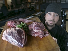 Jim Renaud, co-owner of The Willistead Restaurant, holds a up a cutting board with tongue, cheek and heart beef parts. Because of the high cost of meat, Renaud is on a quest to offer more variety using alternative cuts of beef and protein choices regularly on the Willistead's menu.