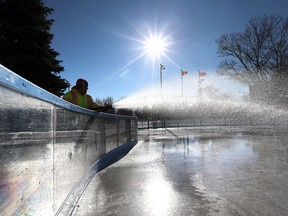 City of Windsor Parks and Recreation employee Doug Romaniuk sprays water on the skating rink at Charles Clark Square in downtown Windsor, Ont. on Jan. 5, 2015.   If mother nature cooperates,  the rink may be ready for skating in a few days.