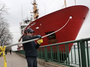 Alain Monfils, a deckhand on the Canadian Coast Guard Samuel Risley places caution tape on the boat's docking lines on Thursday, January 28, 2016, in downtown Windsor, ON. as the crew prepared to dock over night. A mild winter has resulted in much less icebreaking duties for the crew.