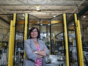 Shelley Fellows is shown in front of industrial robotics equipment at her company, Radix Inc. - John Chan photo