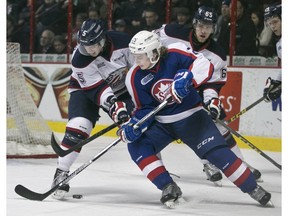 Windsor's Cole Carter tries to get a shot off while being defended by Saginaw's Marcus Crawford, left, earlier this month at the WFCU Centre.  On Sunday, the Spitfires lost 2-0 to the Spirit in Saginaw.