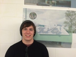 University of Windsor visual arts student Garrett Seifarth stands in front of a drawing of his group's plans for the Drouillard Road underpass on Tuesday, Dec. 1, 2015.