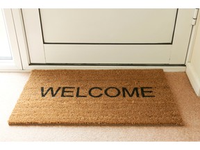 Welcome mat inside doorway of home. Photo by fotolia.com.