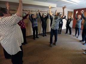 Christopher Lyons leads a laugh yoga class at the Alzheimer Society of Windsor Essex County recently. The group is hosting a laughing event fundraiser at the Devonshire Mall later this month.