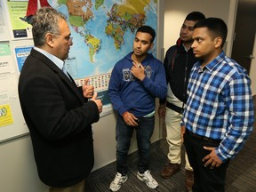 University of Windsor International student advisor Enrique Chacon, left, offers a soft landing session with new foreign students Amrit Duggal, Deepak Sonie and Manik Affarwal, right,  December 15, 2015. The students will be studying for their masters in mechanical engineering.