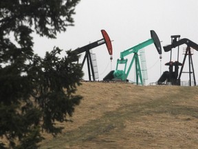 Pumpjacks sit on a hill overlooking the drilling site for Legacy Oil and Gas southwest of Turner Valley on April 28, 2014.