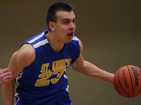 St. Anne Saints Anthony Zrvnar carries the ball in senior boys basketball action in this 2015 file photo.