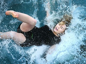 Mariah Renaud, vice-president on the Student Representative Council at St. Clair College  plunges into the ice-cold water during the 2016 Polar Plunge event at St. Clair College in Windsor on Feb. 3, 2016.