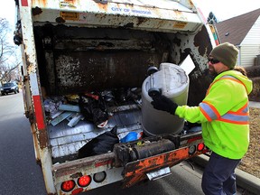 A worker with GFL picks up garbage on the 1200 block of Partington Avenue Monday, Feb. 22, 2016. The man has worked with GFL for six years and identified himself as Guy.