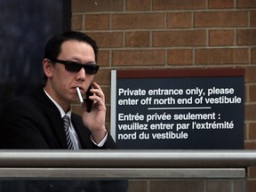 In this file photo, salesman Dennis Lee is shown outside Superior Court of Justice, Feb. 22, 2016, during his fraud and theft trial