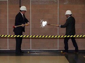 Mayor Drew Dilkens, left, and councillor Fred Francis swing sledgehammers to symbolically get the renovation process started at South Windsor Recreation Complex Feb. 25, 2016.  A 13,000 square foot expansion by DeAngelis Construction is underway at South Windsor Recreation Complex. A gymnasium, pre-school and nursery rooms along with craft and dance rooms are being added to make room for programs once held by nearby Oakwood Community Centre.