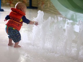 A toddler plays in the water at the Adventure Bay Family Water Park in Windsor on Friday, Feb. 12, 2016.
