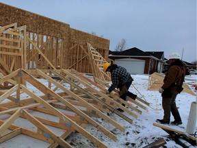 Framers Abe Neufeld, left, and Neil Loewen work on a housing development on Riverfront Park Place at Sandwich Street South in Amherstburg on Monday Feb. 15, 2016.