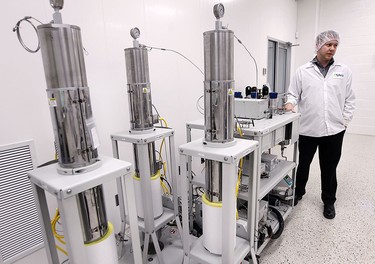 Bryan Landschoot, a chemist and oil extraction technician is shown on Thursday, Feb. 18, 2016, at the Aphria greenhouses in Leamington, Ont. with some of the newly purchased equipment.