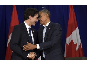 U.S. President Barack Obama, right, and Canada's Prime Minister Justin Trudeau, left, stand to shake hands following their bilateral meeting at the Asia-Pacific Economic Cooperation summit in Manila, Philippines, Thursday, Nov. 19, 2015.
