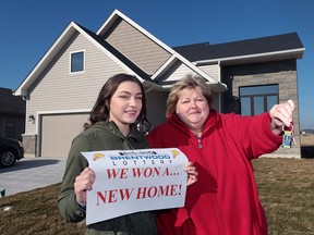 Brentwood lottery dream home winner Angel Gerard poses in front of the home she won along with her daughter Katarina in Kingsville, Ont. on Friday, Feb. 5, 2016 when she was presented with the keys.