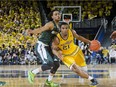 Michigan State guard Bryn Forbes, left, defends Michigan guard Zak Irvin (21) in the second half of an NCAA college basketball game at Crisler Center in Ann Arbor, Mich., Saturday, Feb. 6, 2016. Michigan State won 89-73.