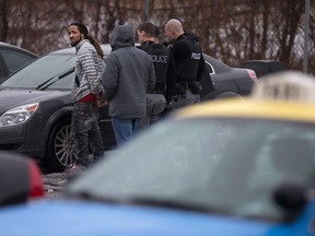 Windsor police officers arrest a man in the parking lot of the McDonald's restaurant at Huron Church Road and College Avenue in Windsor on Feb. 24, 2016.