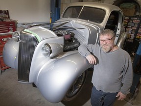 Jim Pollier, 52, stands next to his fully customized 1937 Chevy in his garage at his home, Sunday, February 21, 2016.