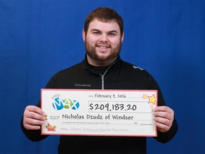 Nicholas Dzudz shows off his winnings from the Feb. 5, 2016 Lotto MAX draw.