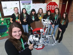 Holy Name Catholic Elementary School students Mackenzie Cassidy, foreground, along with Sarah Busch,  back left, Emily Stanley,  Samantha Wise, Megan Thorne,  Jessica Tannous, Judah McKinley  and Emma Beaulieu display their award-winning robotics project in Essex.  JASON KRYK