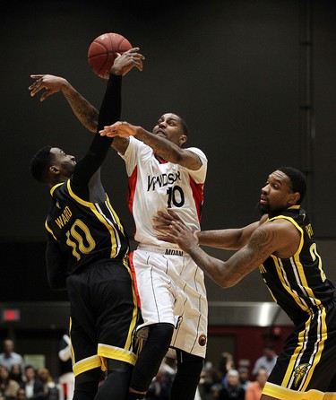 The Windsor Express' Brandon Robinson gets caught between the London Lightnings Warren Ward and Akeem Wright (right) during the Clash at the Colosseum at Caesars Windsor on Wednesday, February 3, 2016.