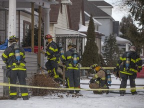 Windsor firefighters work at the scene of a house fire at 395 Curry Ave., Saturday, February 13, 2016.