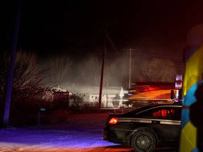 A train passes by the scene of a house fire in the 200 block of Golfview Drive in Belle River on Wednesday, Feb. 11, 2016
