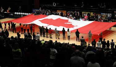 Members of the Great Canadian Flag project unveil a huge Canadian flag prior to the start of the Clash at the Colosseum at Caesars Windsor on Wednesday, February 3, 2016.