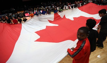 Members of the Great Canadian Flag project unveil a huge Canadian flag prior to the start of the Clash at the Colosseum at Caesars Windsor on Wednesday, February 3, 2016.