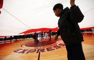 Members of the Great Canadian Flag project unveil a huge Canadian flag prior to the start of the Clash at the Colosseum at Caesars Windsor on Wednesday, February 3, 2016.