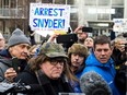 Flint, Mich., native and filmmaker Michael Moore attends a rally outside city hall in Flint, Mich., on Saturday, Jan. 16, 2016, accusing Gov. Rick Snyder of poisoning the city's water.
