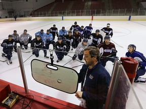 Former Flint Firebirds head coach John Gruden is shown with his players Wednesday, Sept. 9, 2015, at the Iceland Arena in Flint, Mich. during practice where the team is preparing for their inaugural season in the Ontario Hockey League.