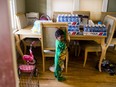 Cases of bottled water rest on the dining room table next to 3-year-old Demetrius Lanier on Monday, Feb. 1, 2016 in his home on the west side of Flint, Mich. Many residents are using bottled water after river water was not treated properly and lead from pipes leached into Flint homes. (Jake May/The Flint Journal - MLive.com via AP)