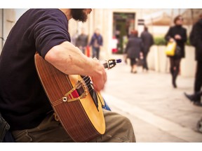 Guitarist playing on the street. Photo by fotolia.com.