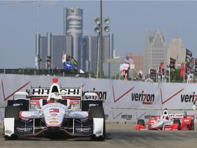 Helio Castroneves takes the second turn during a practice session for the first race of the IndyCar Detroit Grand Prix auto racing doubleheader Saturday, May 30, 2015, in Detroit.