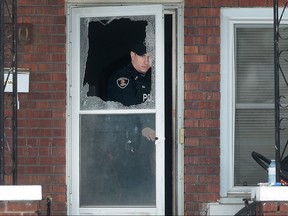 A Windsor police officer investigates an alleged assault on Tuesday, Feb. 16, 2016 in the 1500 block of Hickory Road in Windsor, Ont. A man was arrested at the scene. The Windsor police emergency services unit was involved with the arrest.