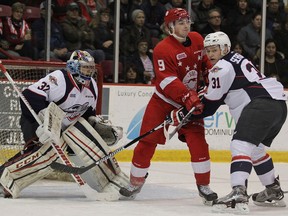 Soo Greyhounds Zachary Senyshyn tangles with Windsor Spitfires Mikhail Sergachev in front of netminder Mario Culina during first-period action at Essar Centre in Sault Ste. Marie, Ont., on Sunday, Feb. 28, 2016.