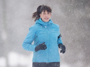 Former smoker Jennifer Jeaurond runs on a snow-covered street recently in Hull, Que. The Canadian Cancer Society is launching a national program to help smokers kick the tobacco habit through running.