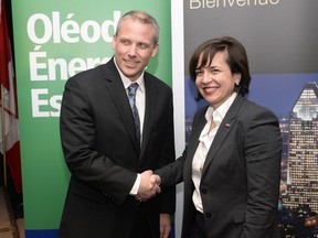 John Soini, president, Energy East pipeline project, and Nathalie Pilon, President and CEO, ABB Canada, shake hands at a news conference in Montreal on Wednesday, Feb. 3, 2016 following the signing of a major supply agreement.