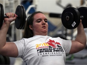 Sara Cowan works out at the Power Pit gym near Belle River on Feb. 24, 2016. She won the trophy for best junior at the 2016 national powerlifting championships.
