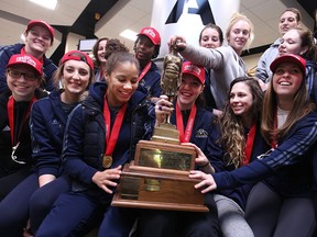 The 2014/2015 University of Windsor Lancers women's basketball team are pictured with the CIS Championship trophy after arriving at Windsor International Airport, Monday, March 16, 2016.